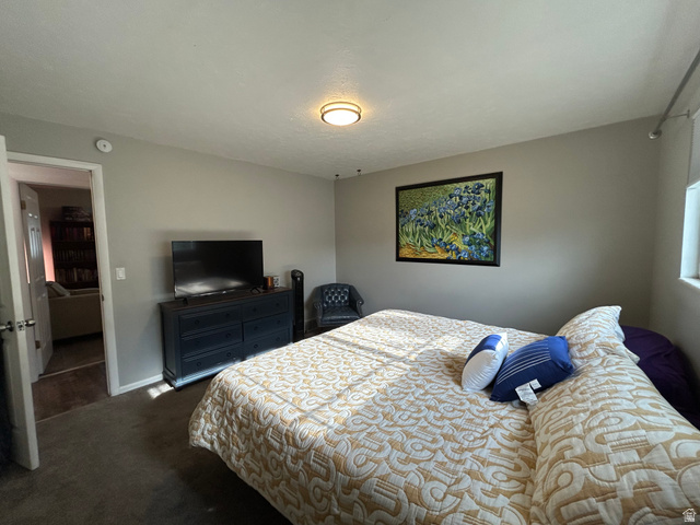 7659 State Street Midvale, UT 84047 - Photo 10 of 33 Bedroom with dark carpet and baseboards