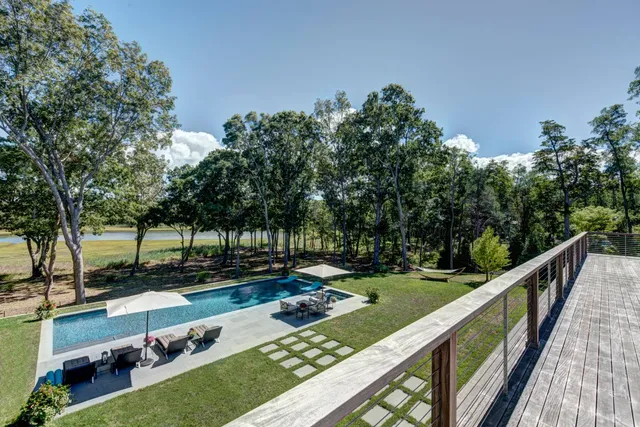 a view of a wooden deck and a yard