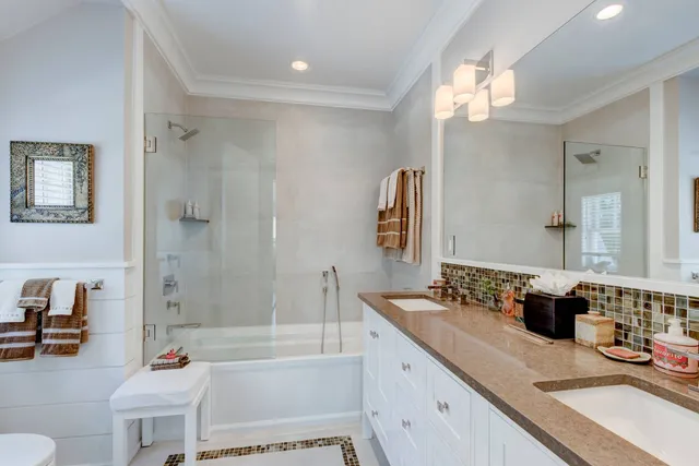 a bathroom with a granite countertop sink mirror toilet and bathtub