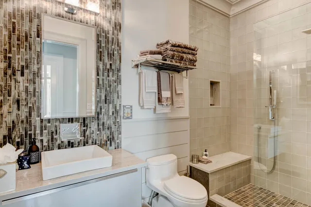 a bathroom with a sink toilet and shower