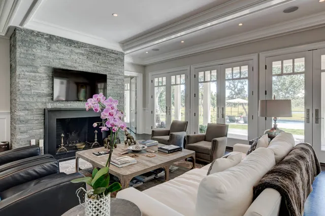 a living room with furniture fireplace and a large window