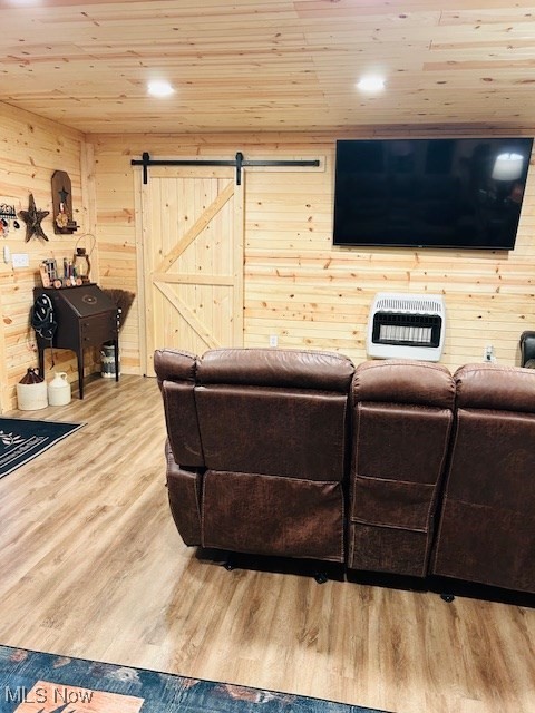 2445 McCord Hill Road Wellsburg, WV 26070 - Photo 7 of 37 Living area featuring a barn door, heating unit, light wood-type flooring, wooden ceiling, and wood walls