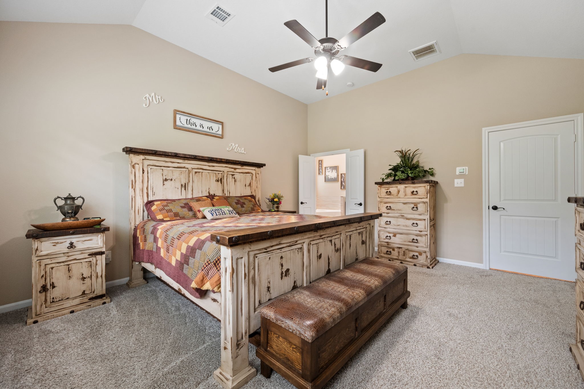 3004 Tyler Street Dayton, TX 77535 - Photo 18 of 34 a bedroom with a bed and a chandelier