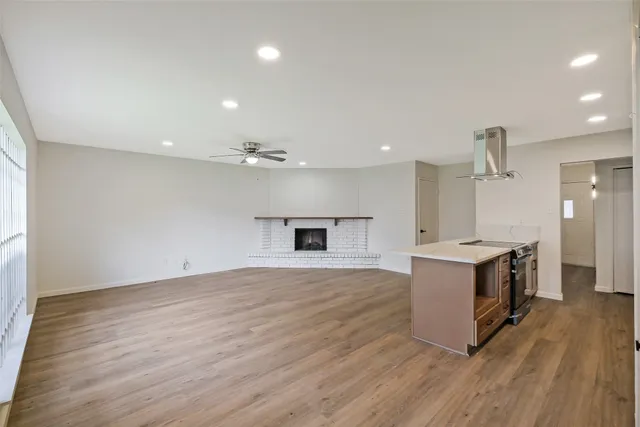 a view of a room with wooden floor cabinet and windows