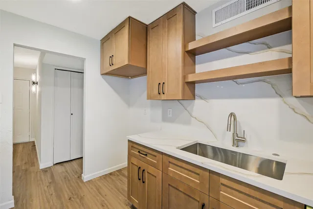 a kitchen with stainless steel appliances a sink a stove and refrigerator
