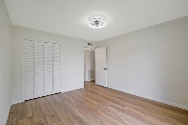 a view of a room with wooden floor and window