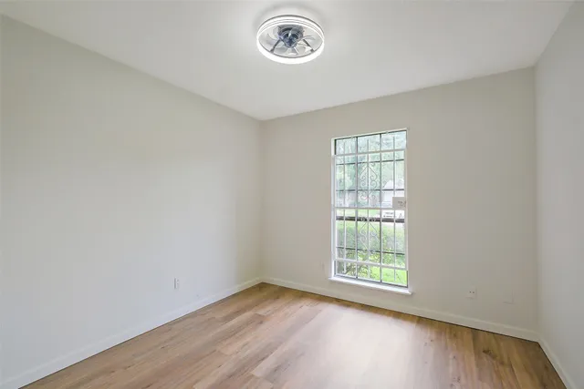 a view of a room with wooden floor