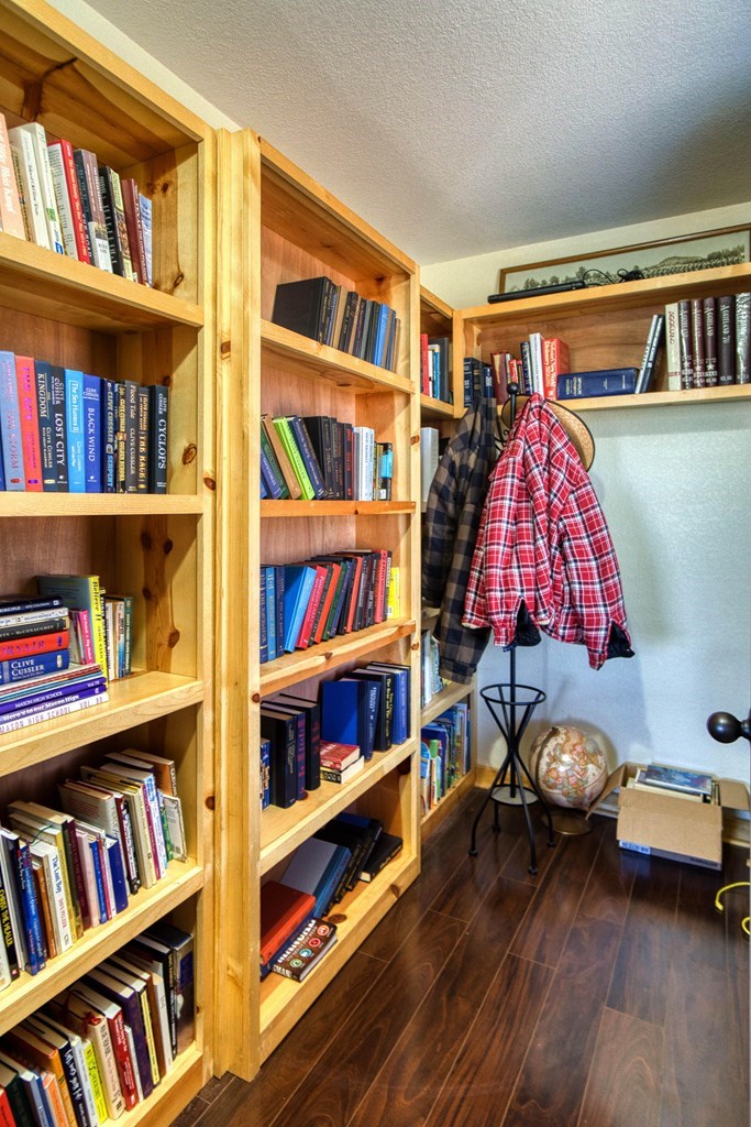 6446 Blackjack Road Fredonia, TX 76842 - Photo 22 of 48 a book shelf with books and knick knacks on it