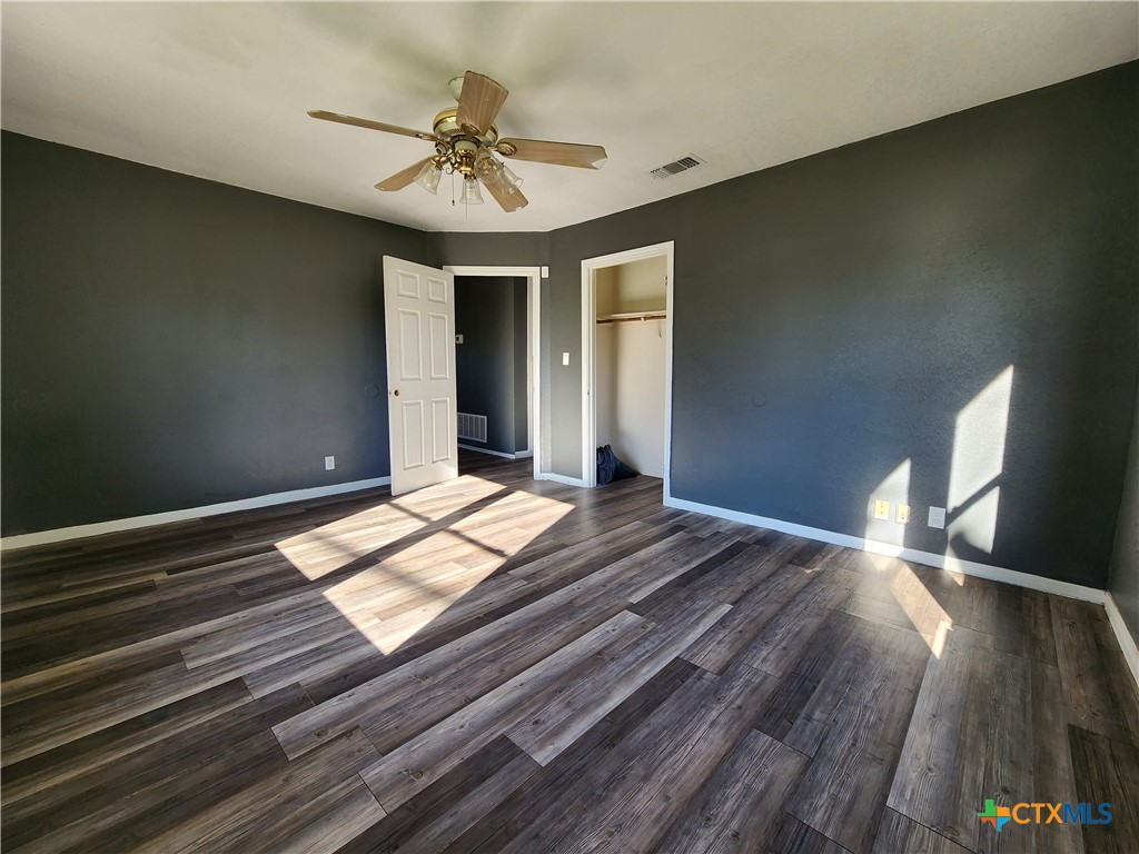 502 North 7th Street Copperas Cove, TX 76522 - Photo 12 of 22 a bedroom with a bed and a chandelier