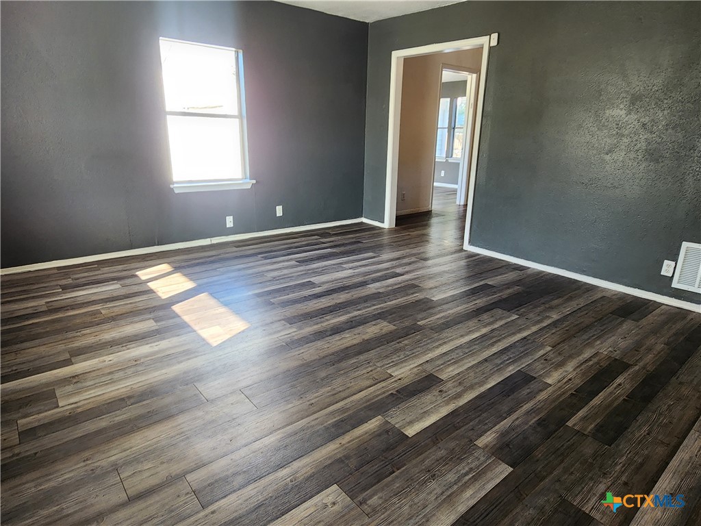502 North 7th Street Copperas Cove, TX 76522 - Photo 3 of 22 an empty room with wooden floor