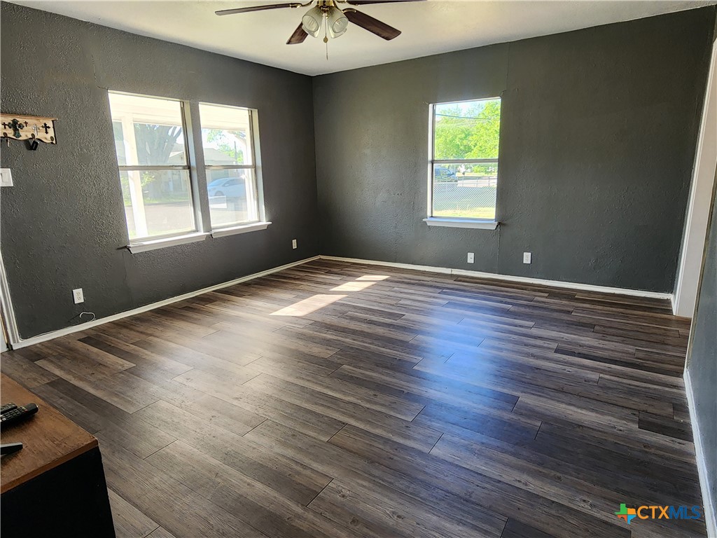 502 North 7th Street Copperas Cove, TX 76522 - Photo 4 of 22 an empty room with wooden floor and windows
