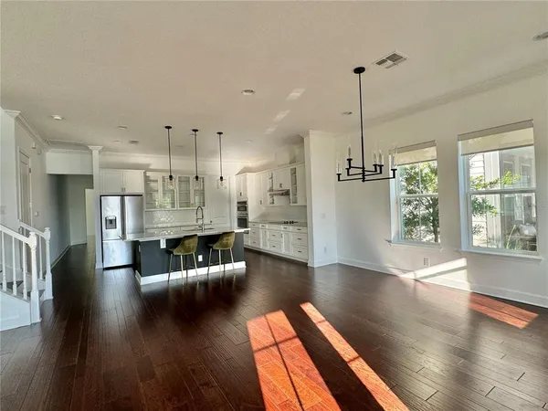 a kitchen with stainless steel appliances granite countertop a sink refrigerator and cabinets