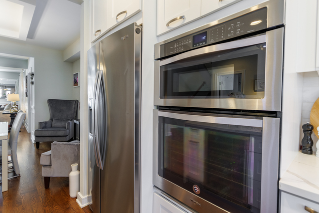 1746 West 104th Place Chicago, IL 60643 - Photo 19 of 58 a kitchen with granite countertop cabinets stainless steel appliances and wooden floor