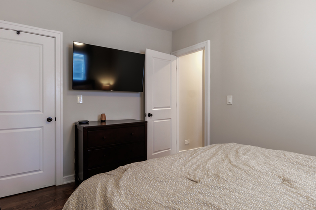 1746 West 104th Place Chicago, IL 60643 - Photo 26 of 58 a bedroom with a bed and a flat screen tv