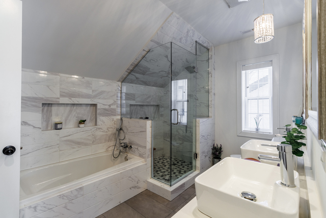 1746 West 104th Place Chicago, IL 60643 - Photo 33 of 58 a bathroom with a bathtub a sink a window and a shower