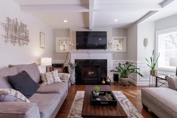 a living room with furniture and a wooden floor