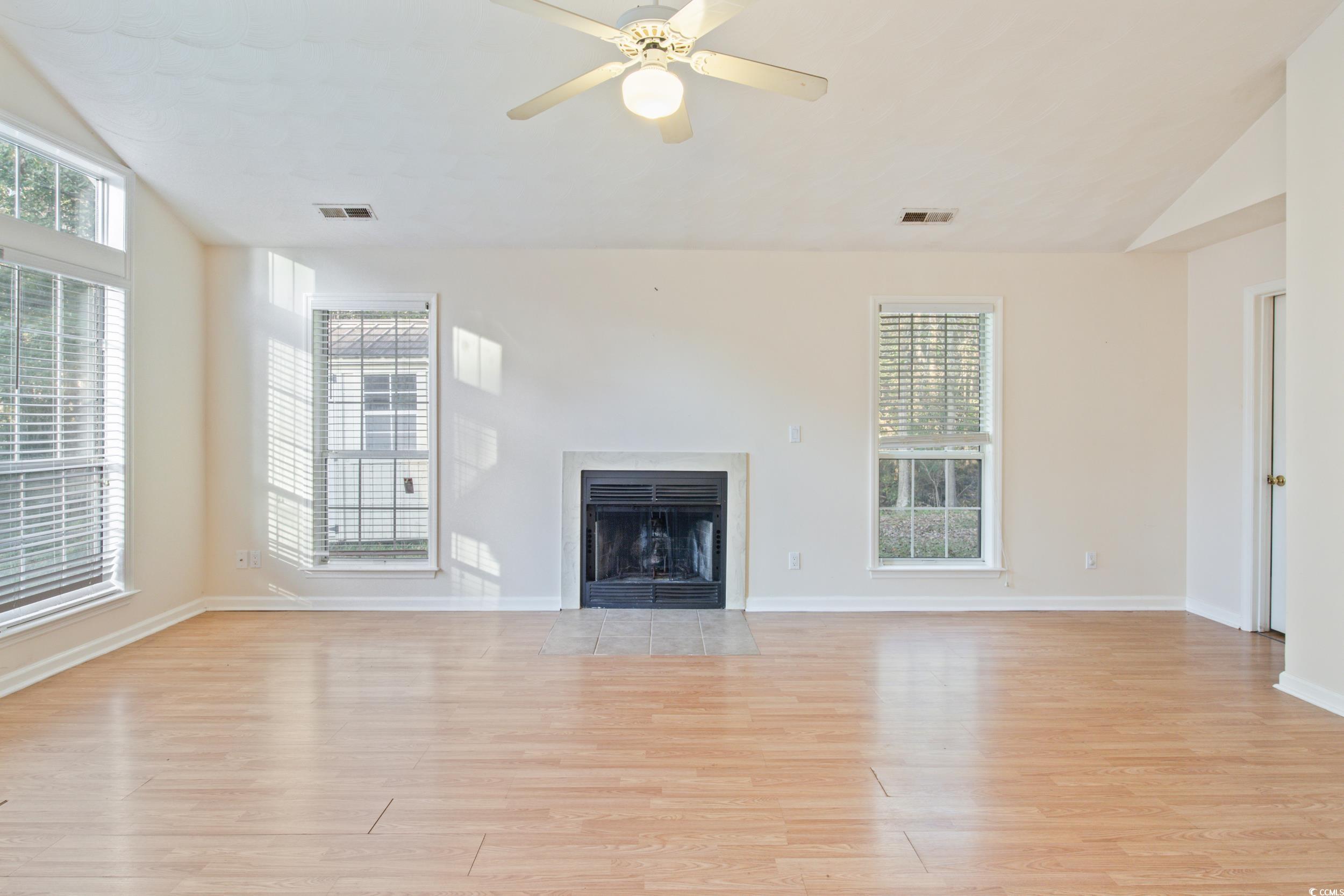 217 Nature Trail Little River, SC 29566 - Photo 11 of 37 Unfurnished living room featuring ceiling fan, vau