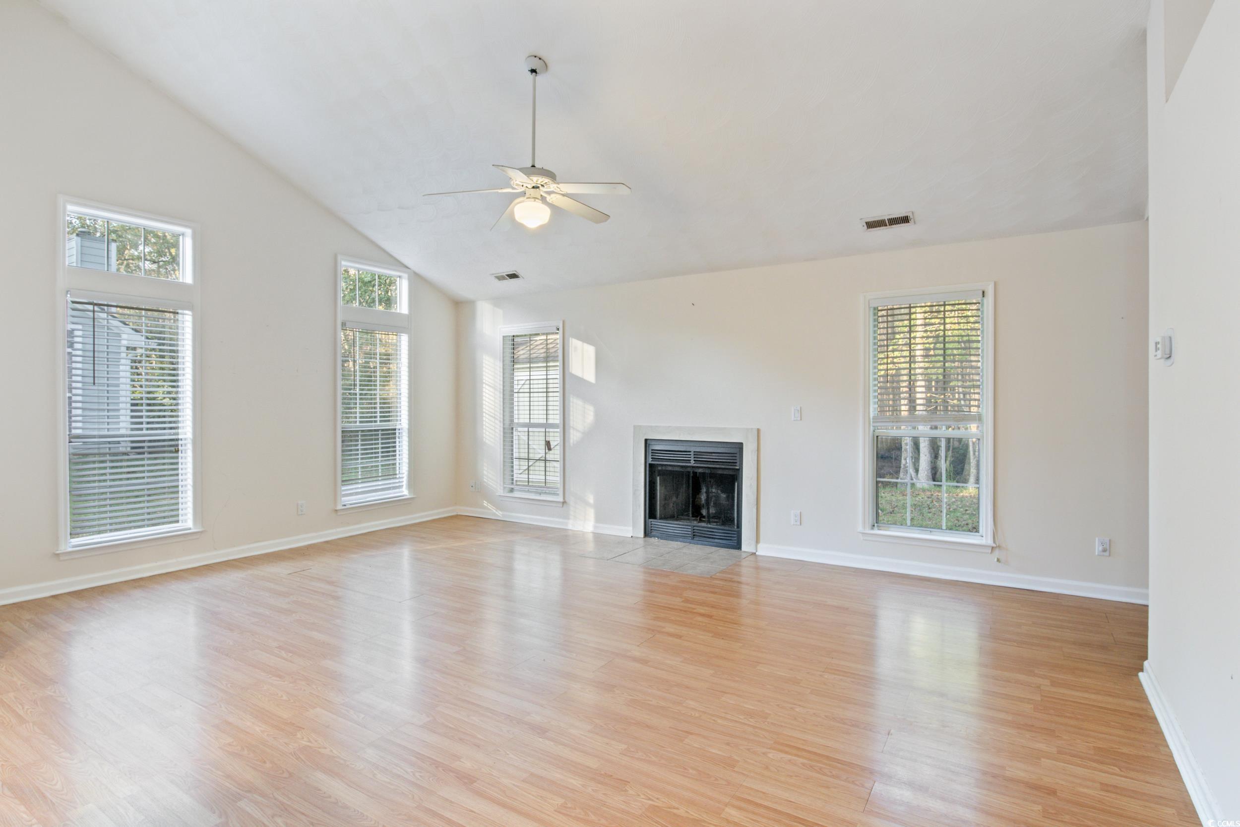 217 Nature Trail Little River, SC 29566 - Photo 13 of 37 Unfurnished living room featuring a wealth of natu