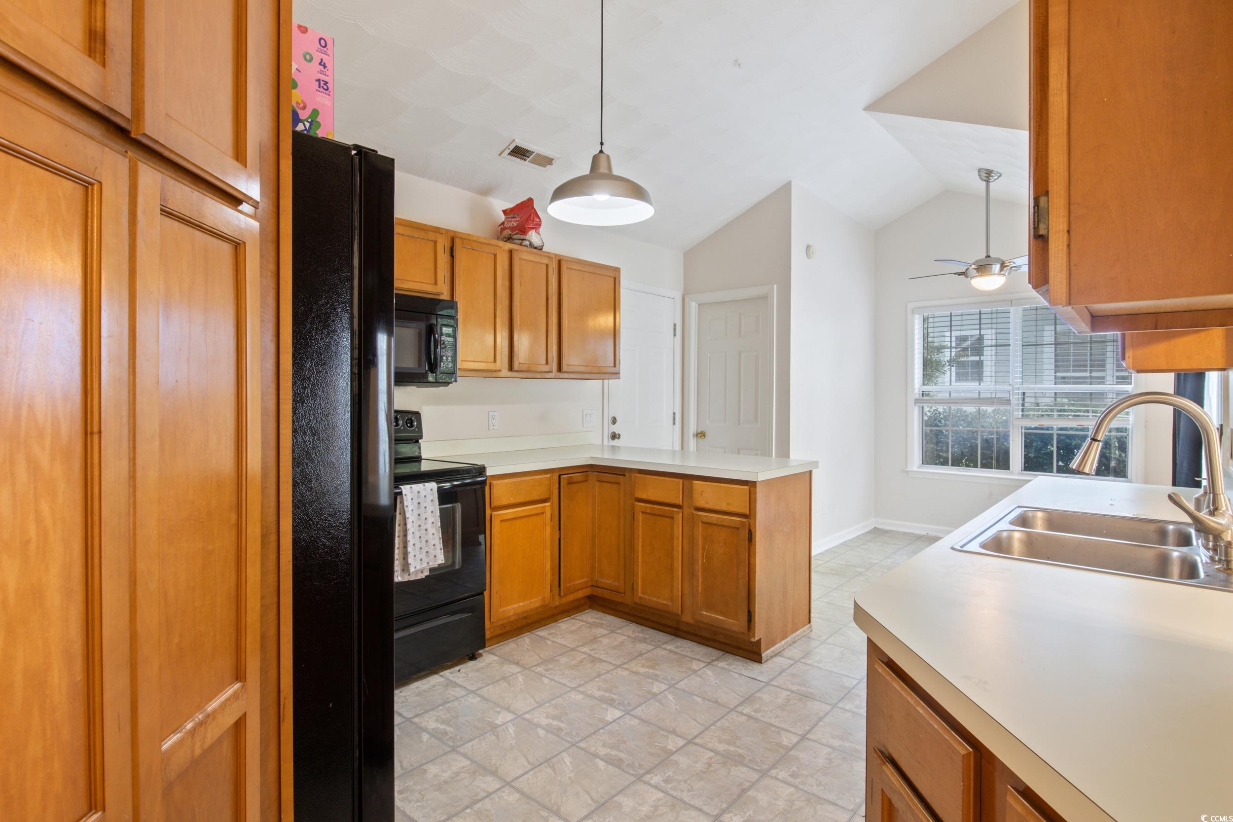 217 Nature Trail Little River, SC 29566 - Photo 15 of 37 Kitchen with black appliances, sink, ceiling fan,
