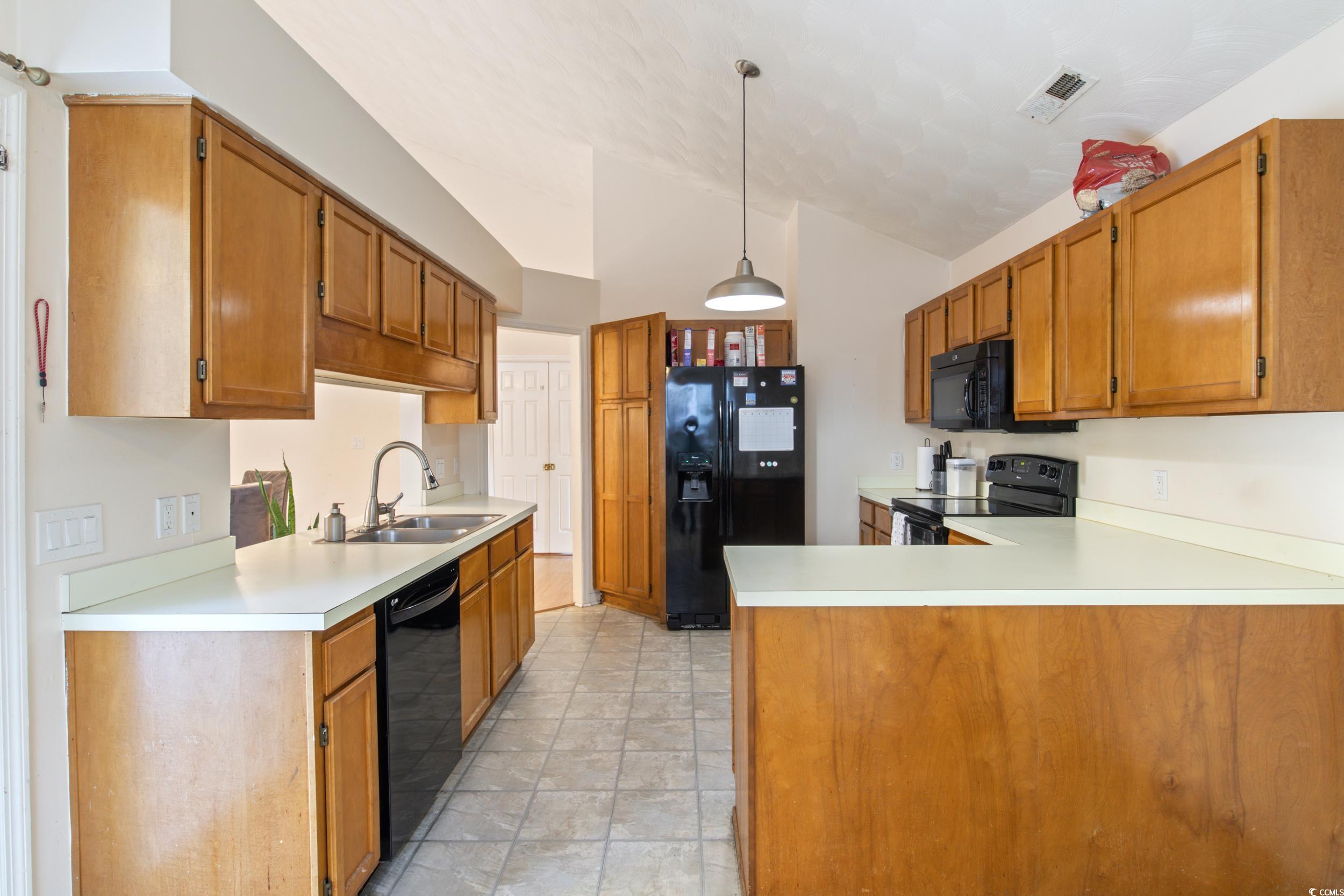 217 Nature Trail Little River, SC 29566 - Photo 16 of 37 Kitchen with kitchen peninsula, vaulted ceiling, b