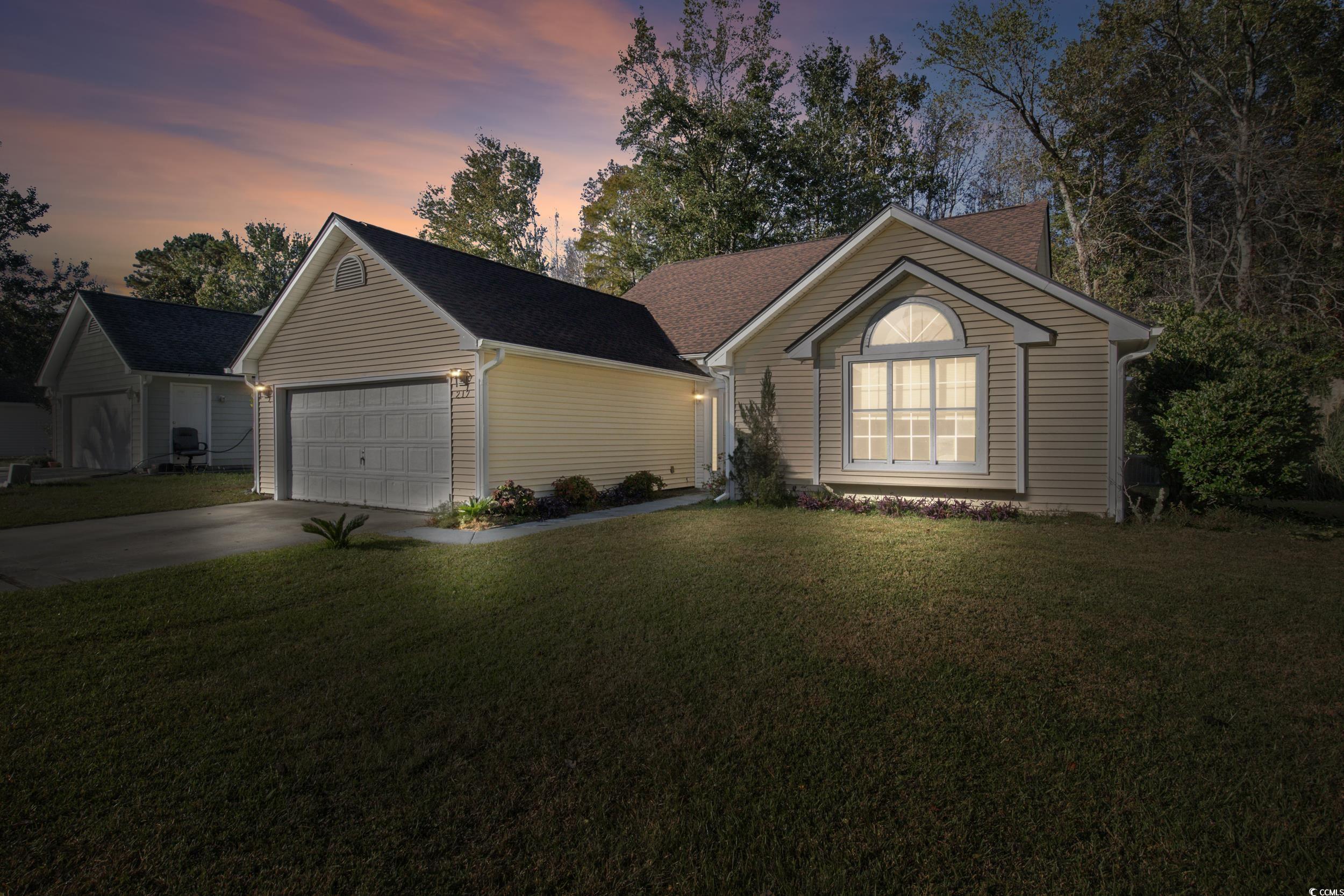 217 Nature Trail Little River, SC 29566 - Photo 2 of 37 Ranch-style home featuring a yard and a garage