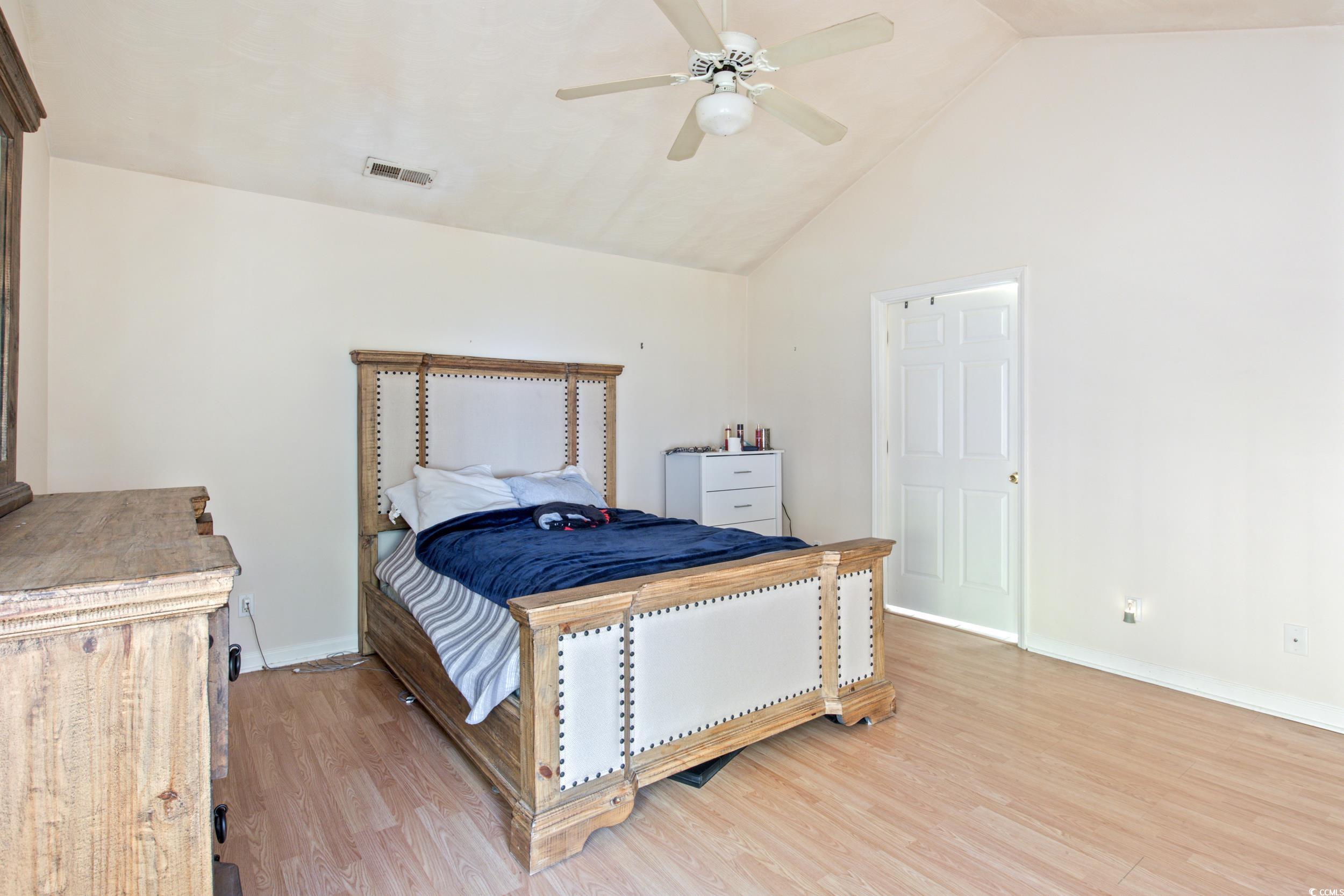 217 Nature Trail Little River, SC 29566 - Photo 21 of 37 Bedroom featuring high vaulted ceiling, light hard