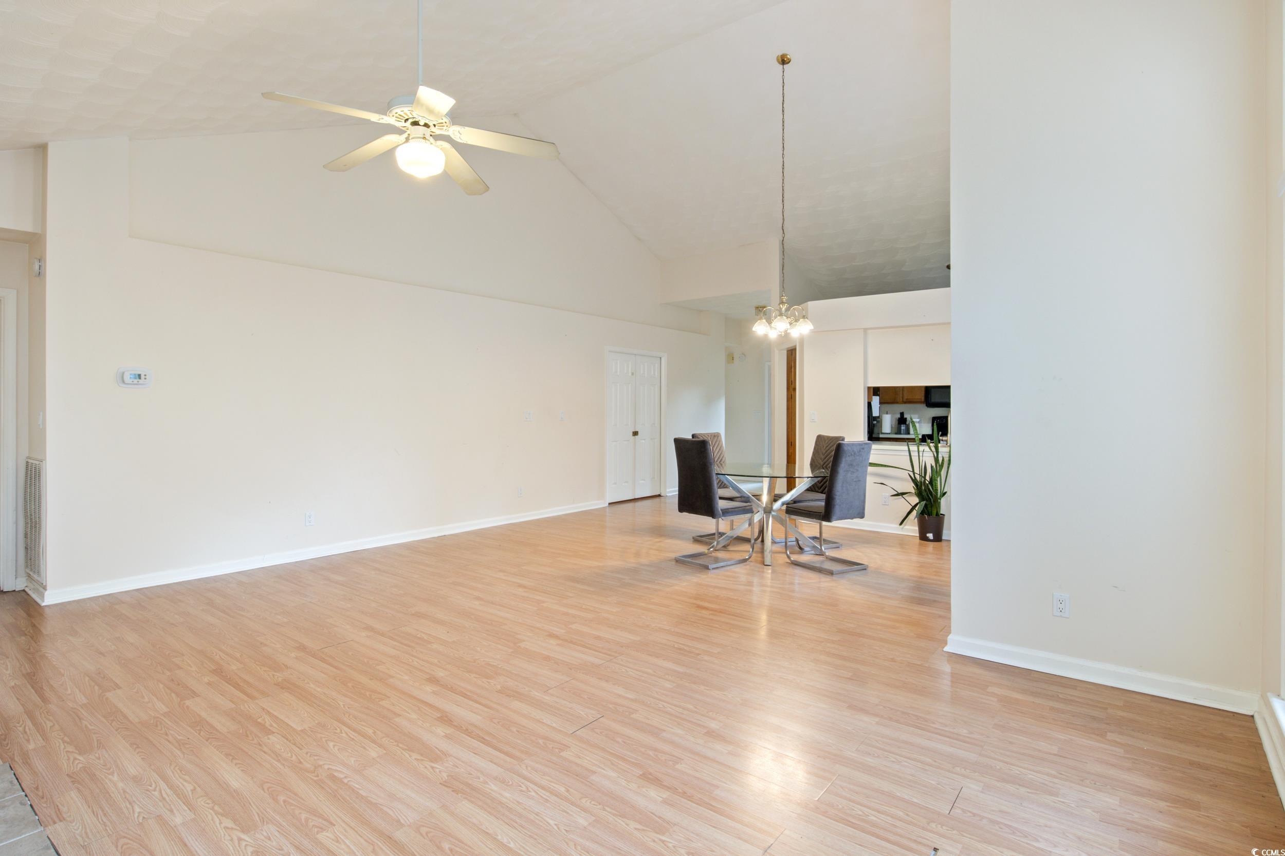 217 Nature Trail Little River, SC 29566 - Photo 9 of 37 Unfurnished living room featuring high vaulted cei