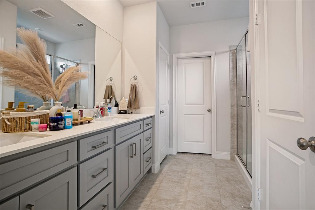 3115 Giovanni Point Princeton, TX 75407 - Photo 16 of 26 Double vanity with light gray shaker cabinetry and white countertops