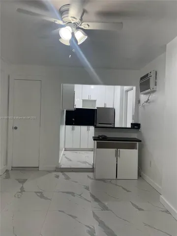 a view of entryway and kitchen