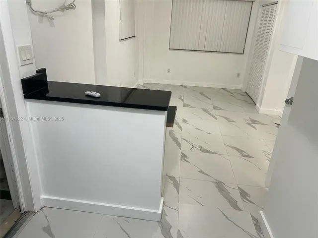 a view of a utility room with closet and fan