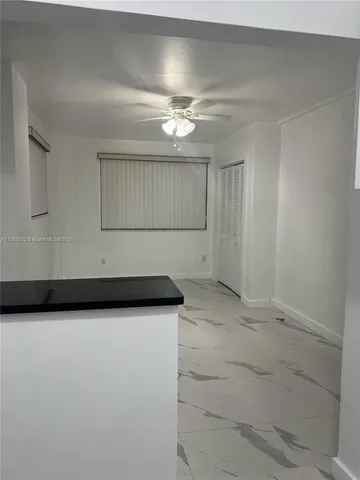 a view of a utility room with cabinets