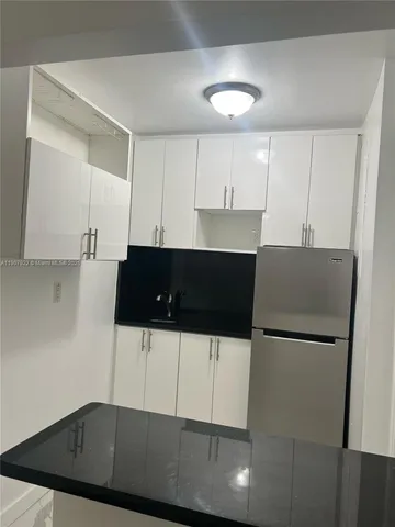 a bathroom with a granite countertop shower and a toilet