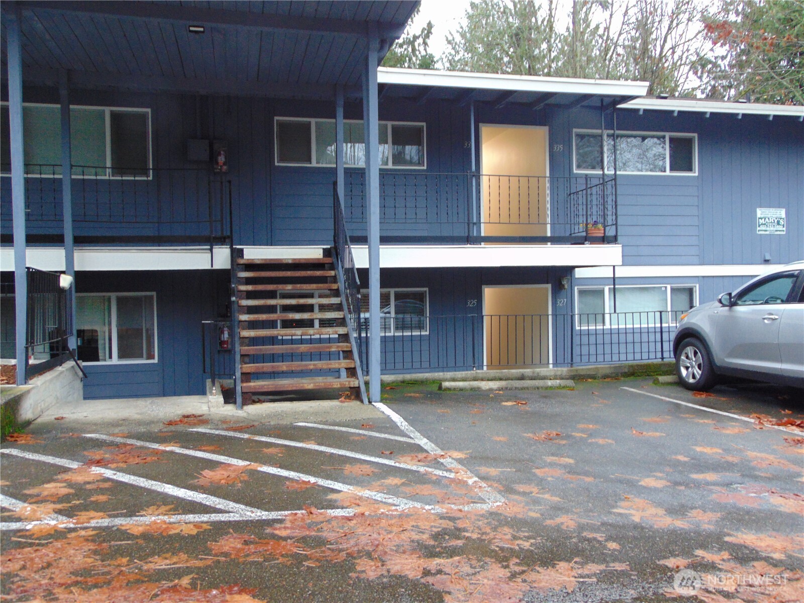 303 Poppy Road Bothell, WA 98012 - Photo 19 of 22 a view of a house with a barbeque and wooden floor
