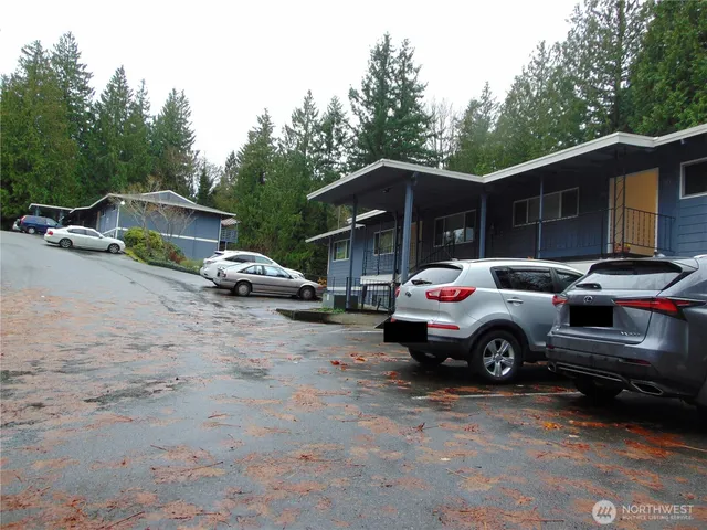 a white car parked in front of a house