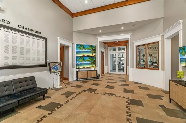 a living room with furniture and large windows