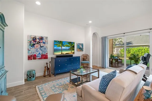 a living room with furniture a window and a flat screen tv
