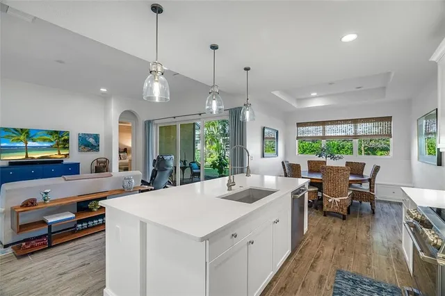 a large white kitchen with a large window