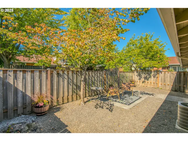 a view of a patio with a table and chairs under an umbrella