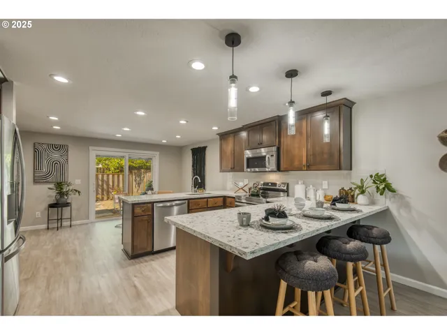 a kitchen with a sink and chairs