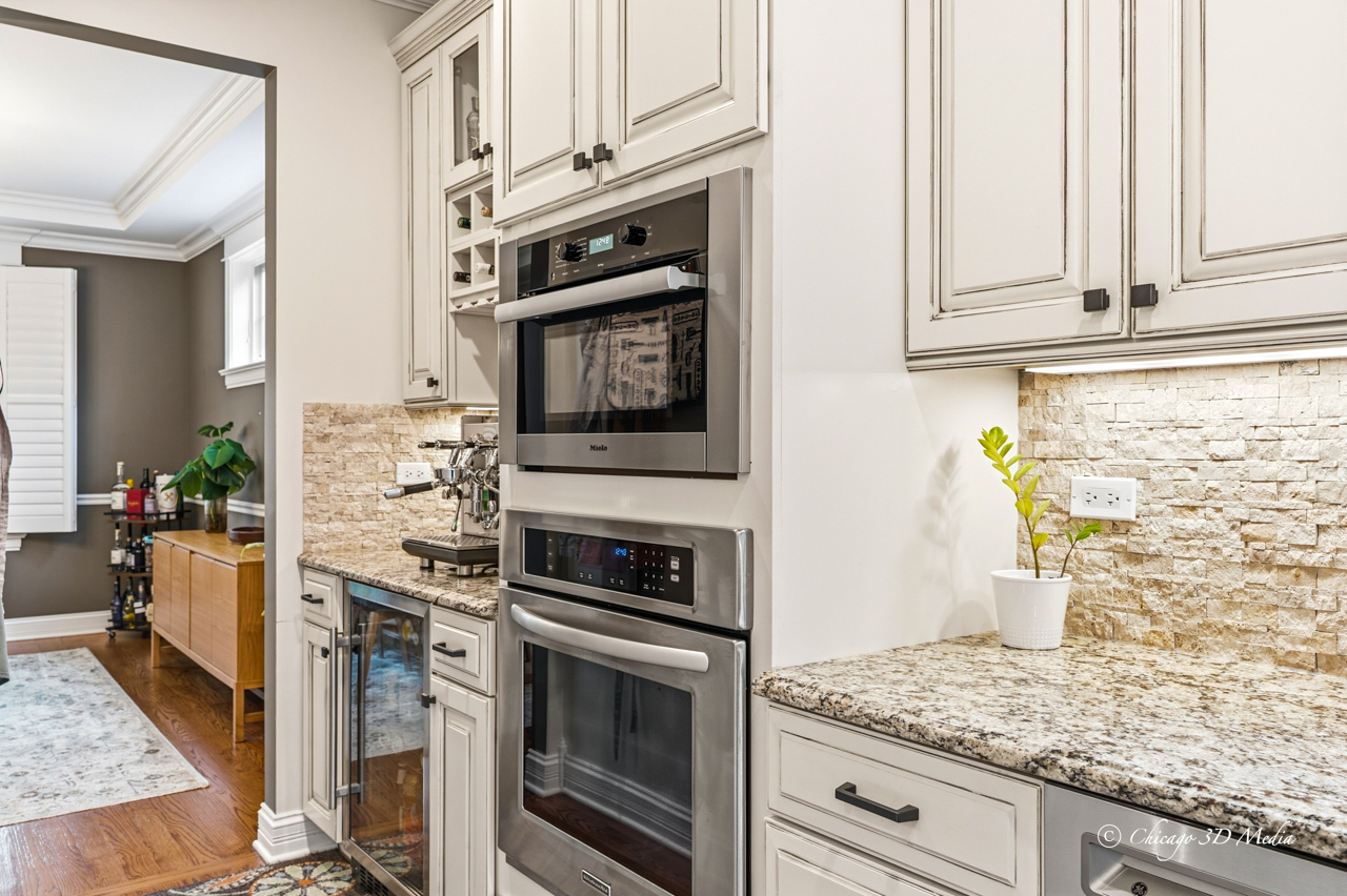 306 17th Street Wilmette, IL 60091 - Photo 16 of 48 a kitchen with stainless steel appliances granite countertop a stove and a microwave
