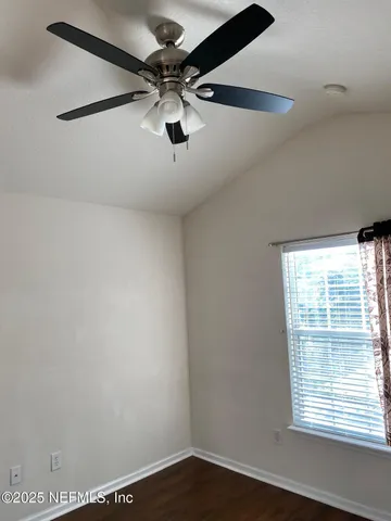 a view of a kitchen with a sink and dishwasher with wooden floor