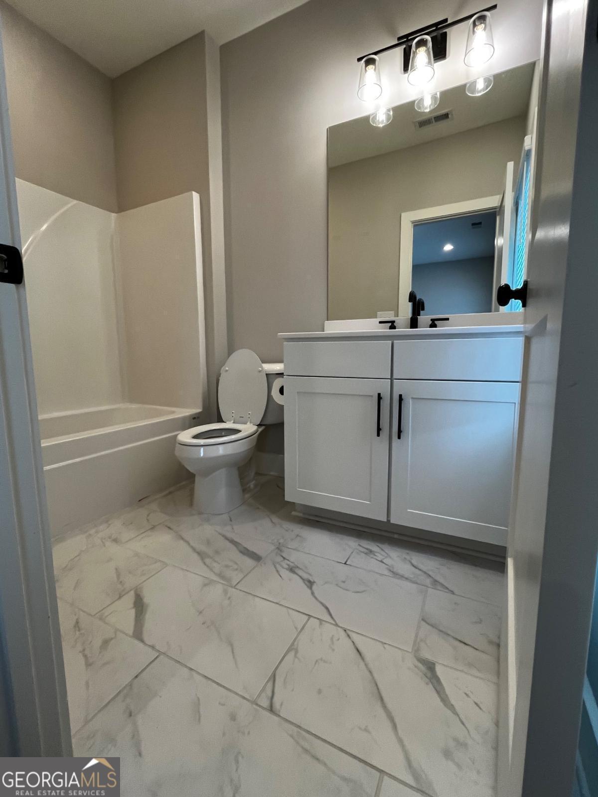 2011 Oak Lane Northeast Atlanta, GA 30318 - Photo 11 of 15 a bathroom with a toilet sink and mirror