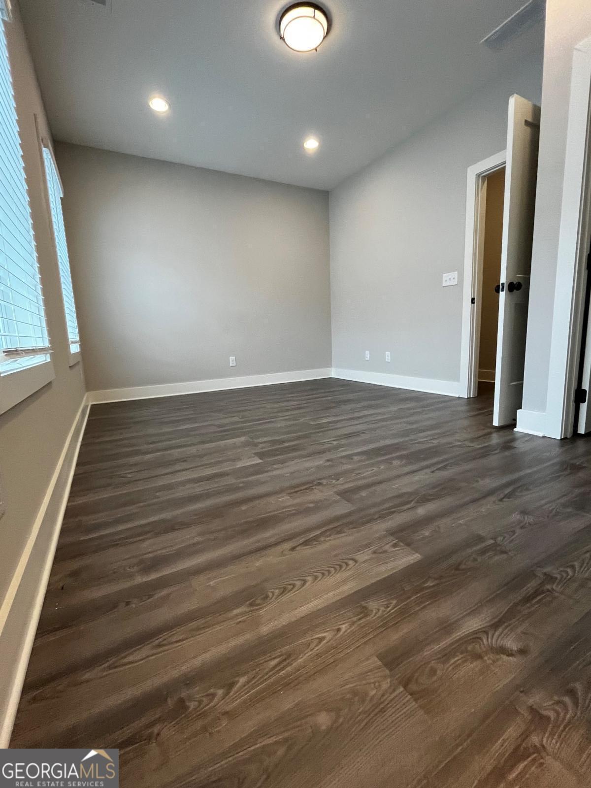 2011 Oak Lane Northeast Atlanta, GA 30318 - Photo 13 of 15 an empty room with wooden floor and windows