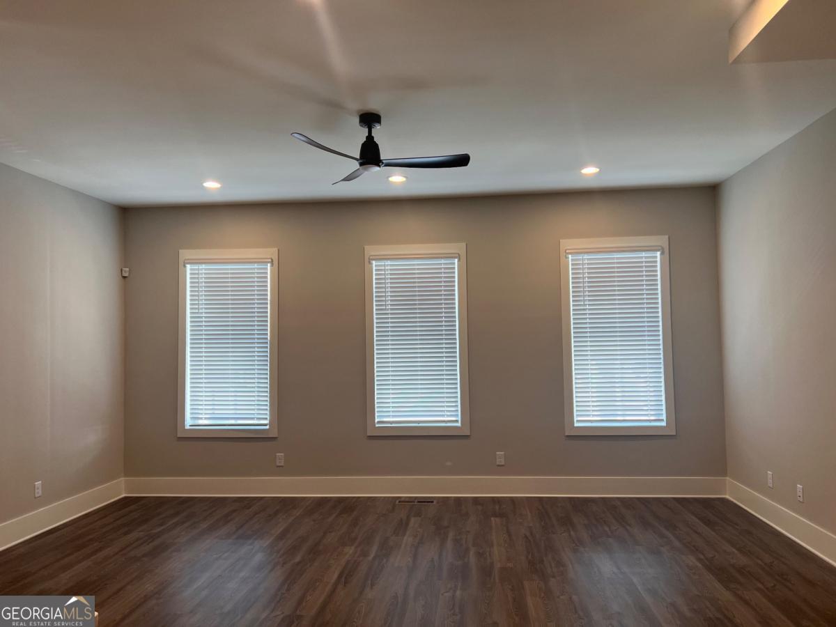 2011 Oak Lane Northeast Atlanta, GA 30318 - Photo 6 of 15 a view of an empty room with wooden floor and a window