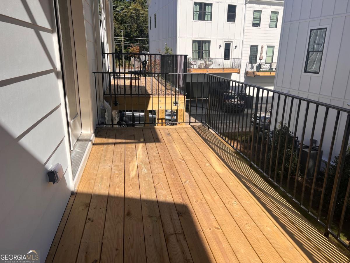 2011 Oak Lane Northeast Atlanta, GA 30318 - Photo 7 of 15 a view of balcony with wooden floor and bench