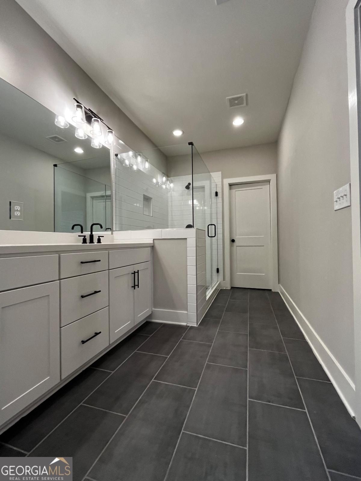 2011 Oak Lane Northeast Atlanta, GA 30318 - Photo 9 of 15 a large bathroom with a large mirror vanity and a sink