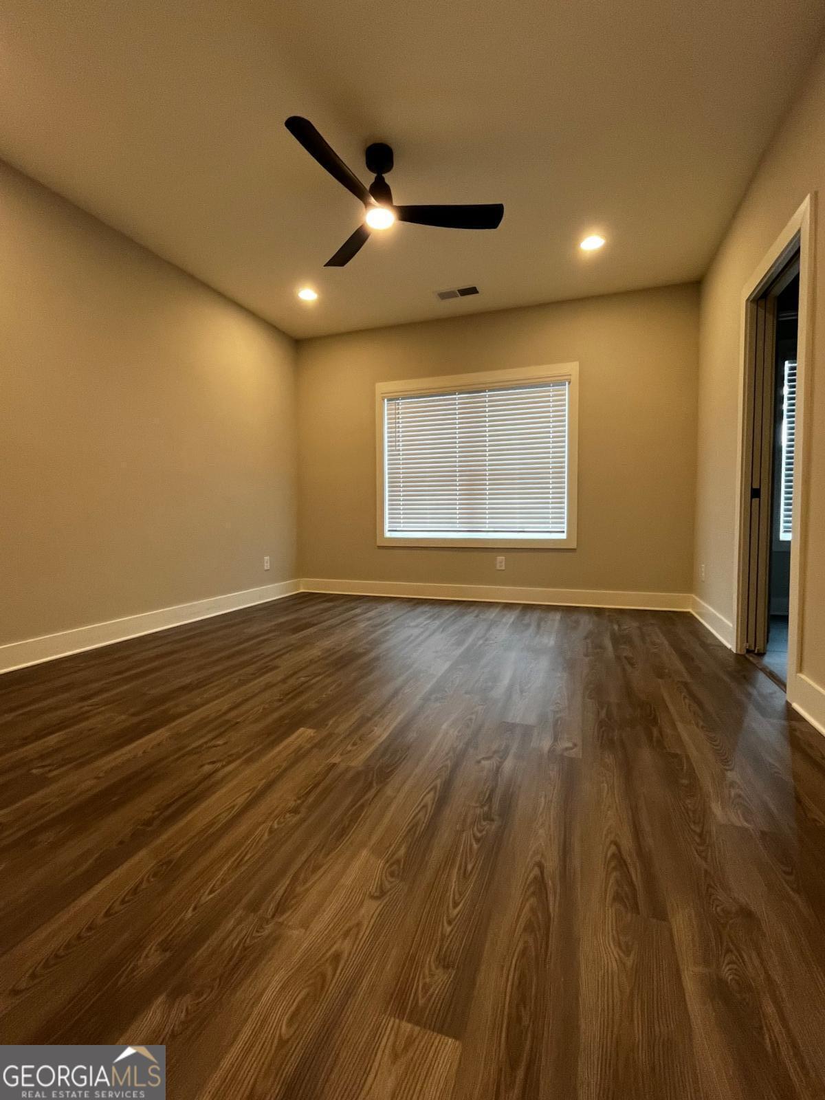 2011 Oak Lane Northeast Atlanta, GA 30318 - Photo 10 of 15 a view of an empty room with wooden floor and a ceiling fan