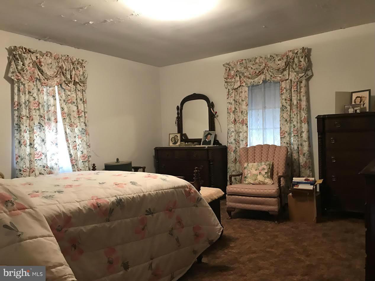 2622 Pleasantville Road Fallston, MD 21047 - Photo 8 of 29 a bedroom with a bed and a black dresser next to a window