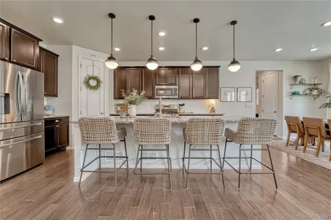a large kitchen with a table and chairs