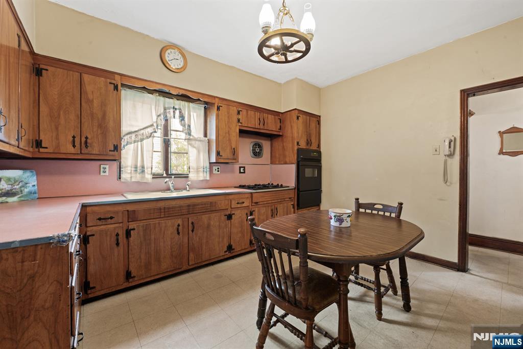 10 Beech Street Rutherford, NJ 07070 - Photo 17 of 41 a kitchen with a table chairs sink and cabinets